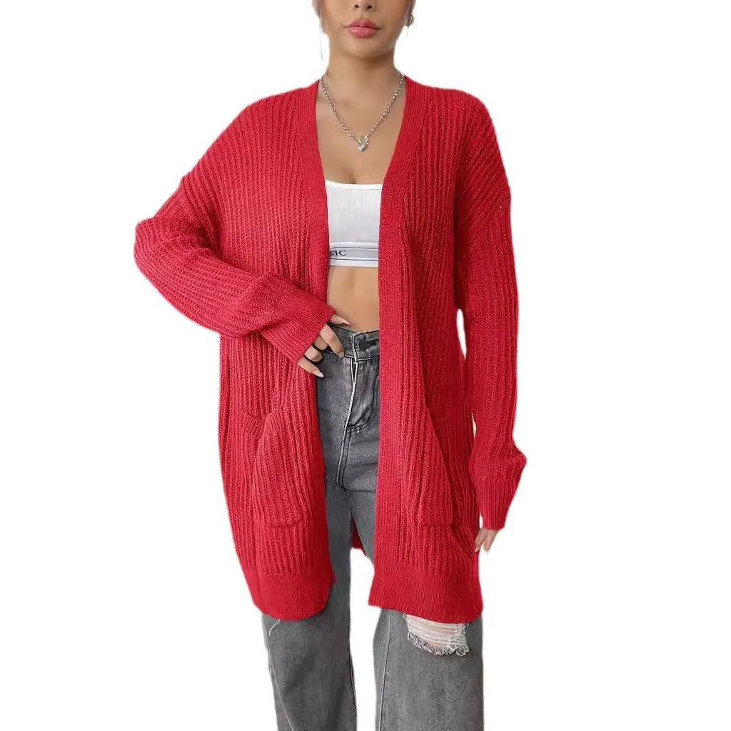 A woman's loose-fit mid-length cardigan in a solid colour, shown on a hanger.