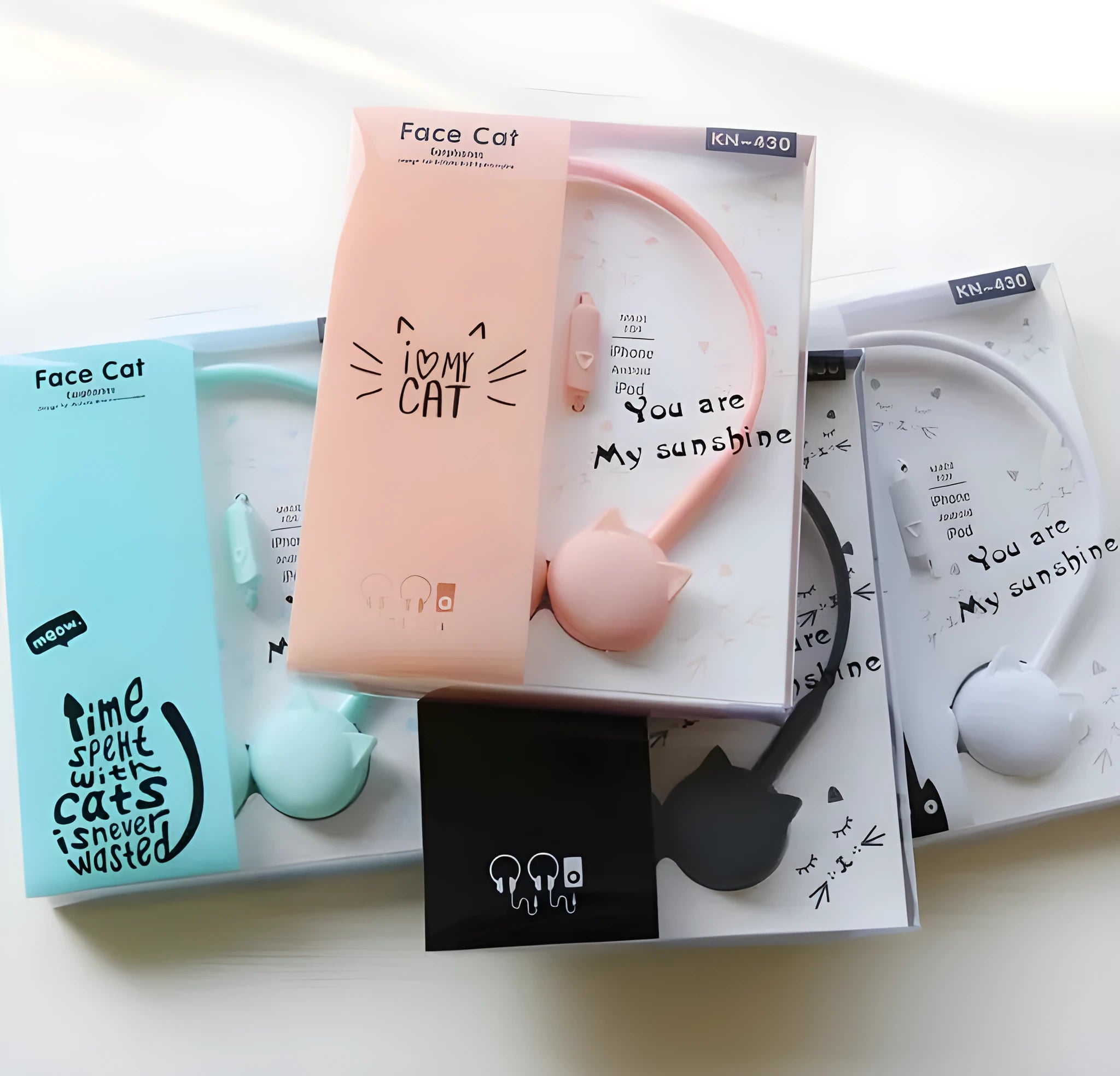 Cute black cat-shaped wired earphones with 3.5mm plug next to blue, pink, and white colour options.