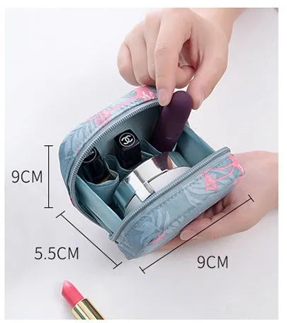 Blue cloth cube-shaped makeup storage bag on a plain background.