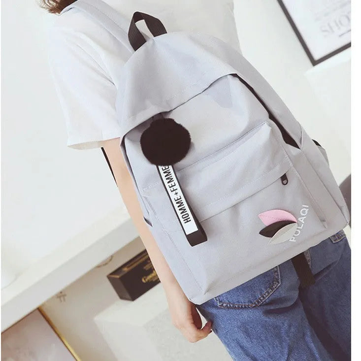Canvas college schoolbag with leaves pattern showing anti-theft features and adjustable shoulder straps