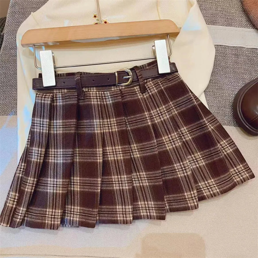Girls' red and black plaid pleated A-line skirt with a cotton blend fabric.