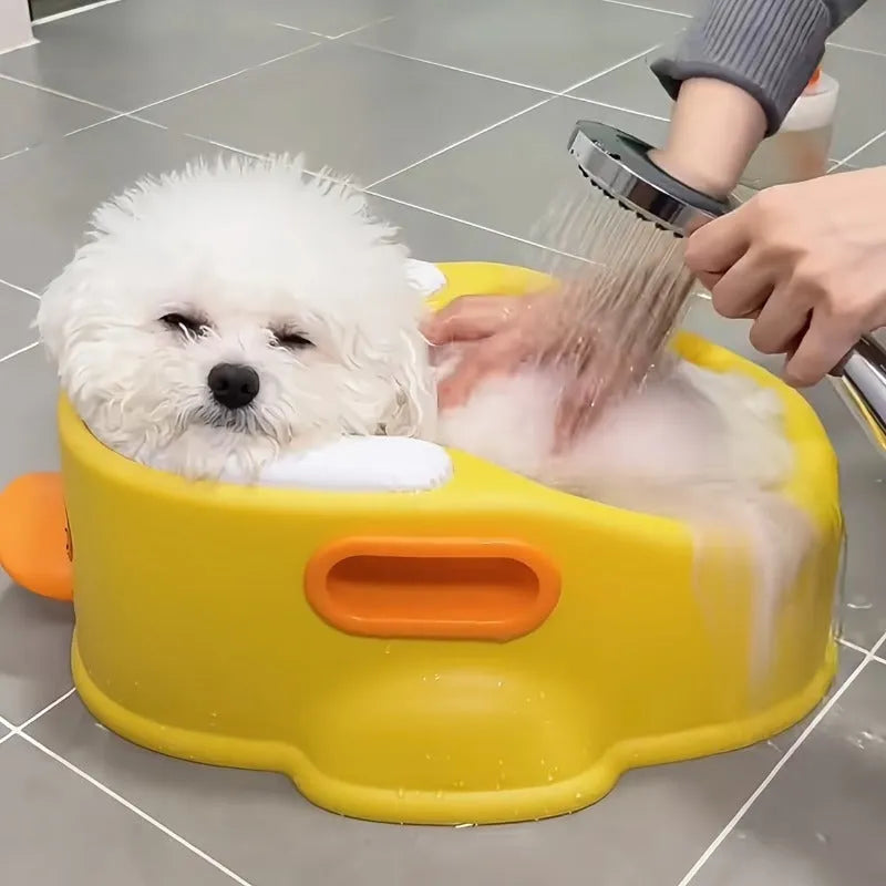 Blue duck-shaped PVC pet bath tub for washing dogs and cats on a floor.