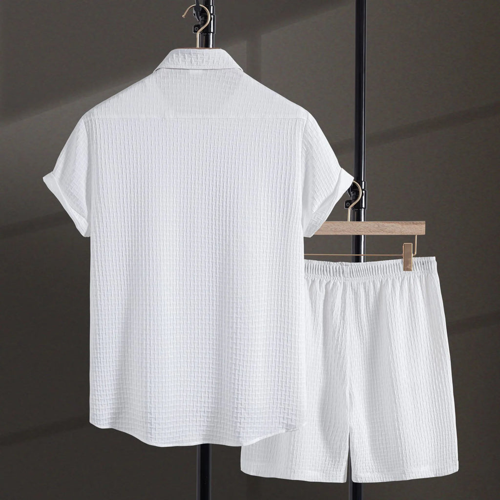 Men's black cotton blend short sleeve shirt and matching shorts laid flat as a summer set.