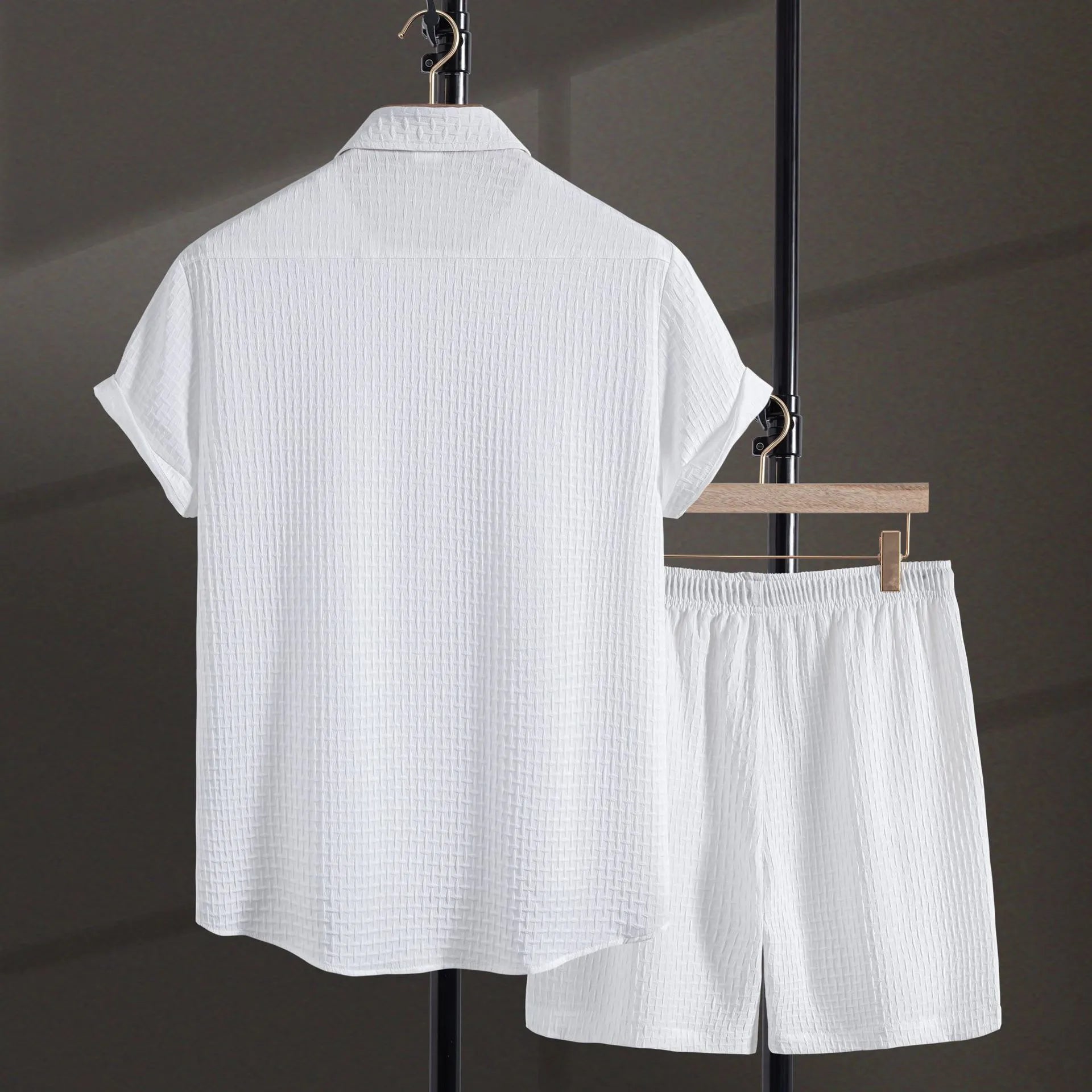 Men's black cotton blend short sleeve shirt and matching shorts laid flat as a summer set.