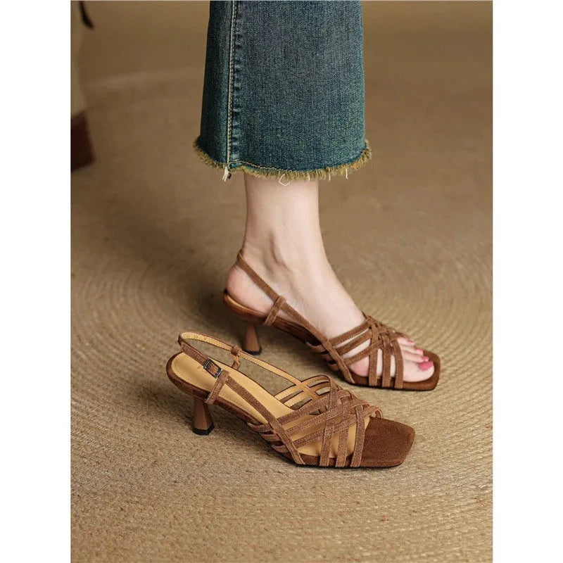 Retro light brown high heel sandals with thin cross straps and an ankle buckle on a square toe.