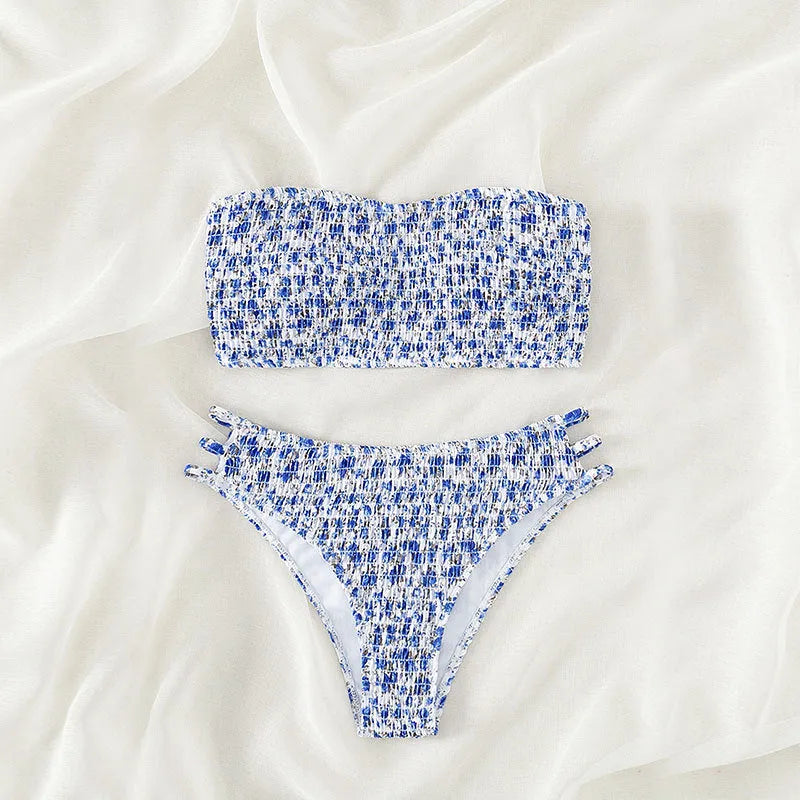 Women's floral strapless swimsuit with high-waisted briefs, open back, and split front design on a mannequin.