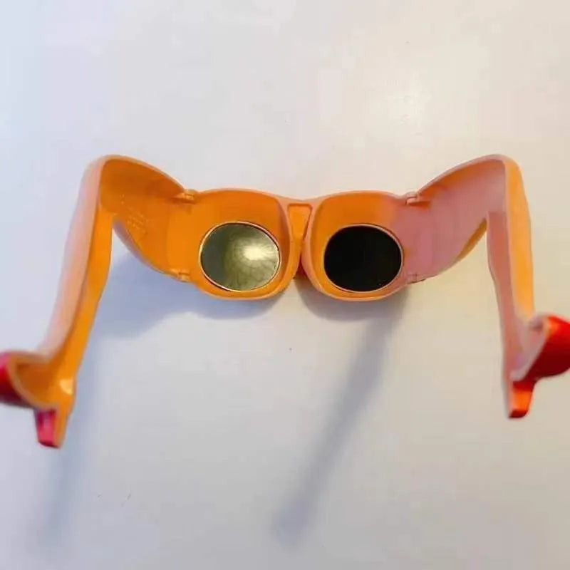 Orange plastic novelty sunglasses accessory for legs and hips on a white background.