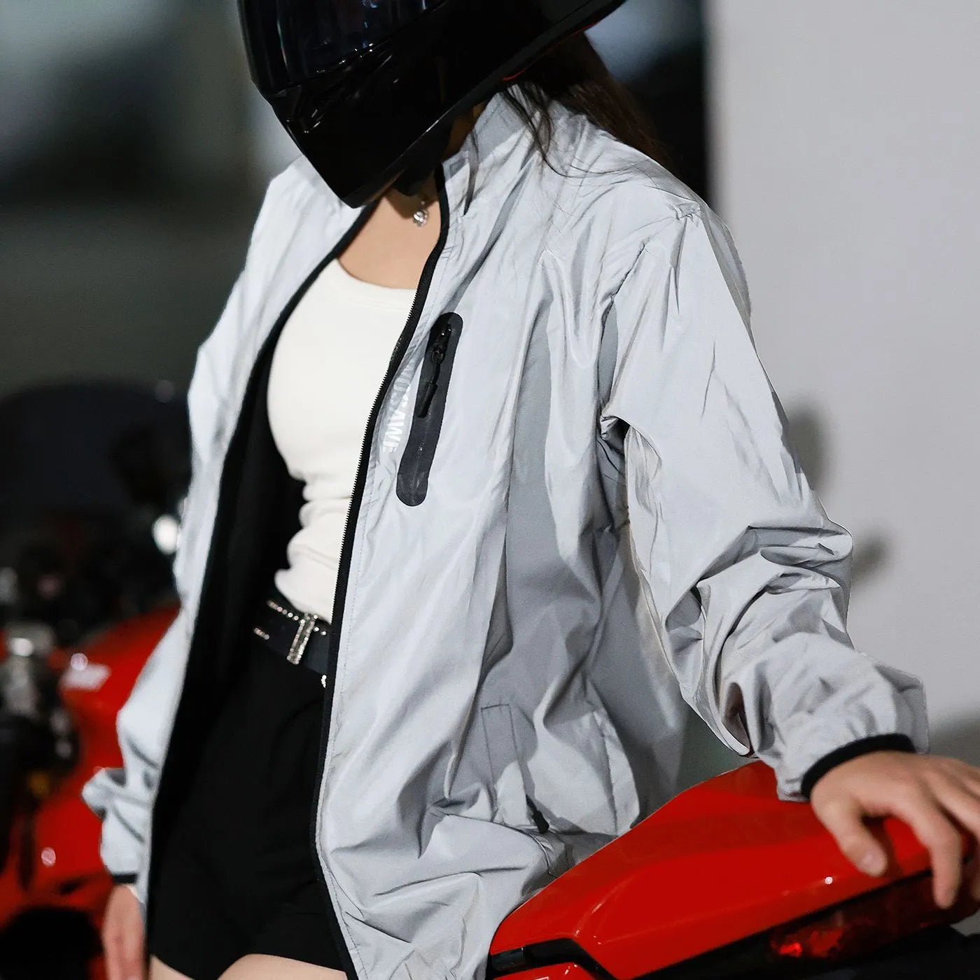 Silver men's waterproof polyester long-sleeved coat on a hanger.