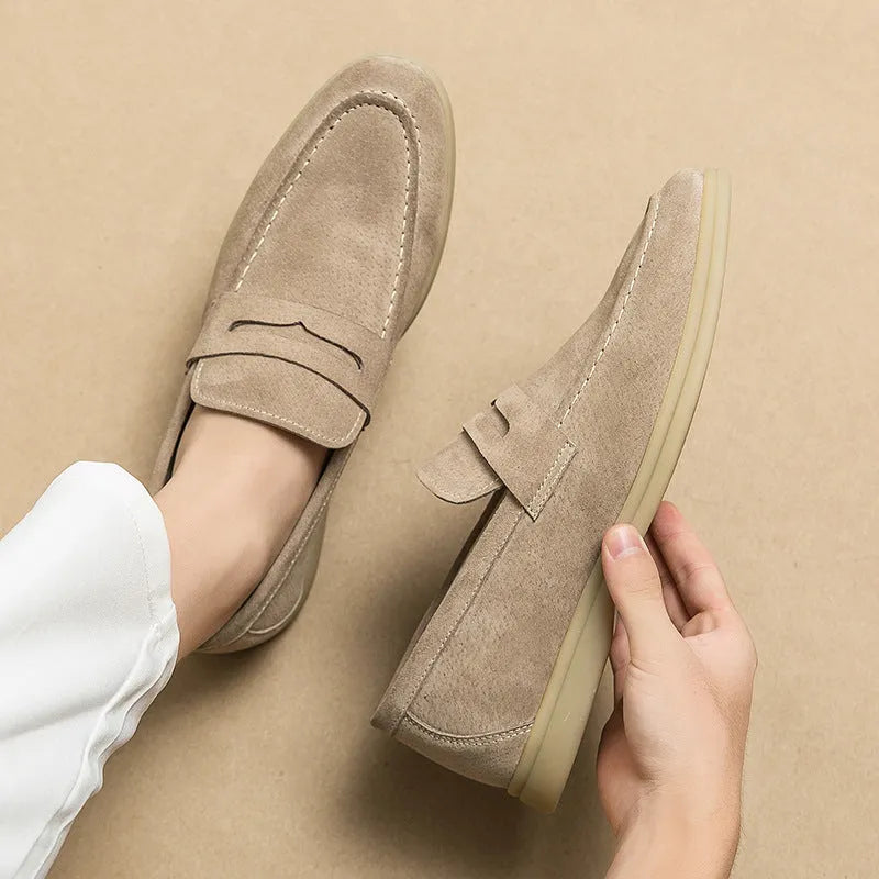 Men's beige leather slip-on casual shoes with a round toe and mid heel on a rubber sole.