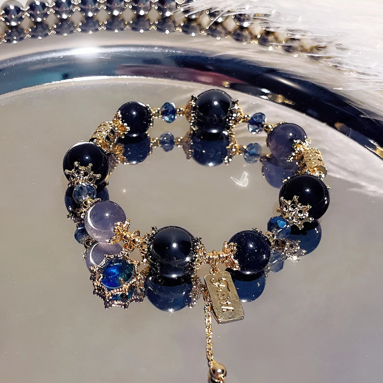 Women's bracelet with snowflake pendant and bow charm in galaxy colours on alloy construction