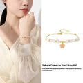 Pink gradient Hetian jade and 925 silver bracelet with epoxy cherry blossom pendant.