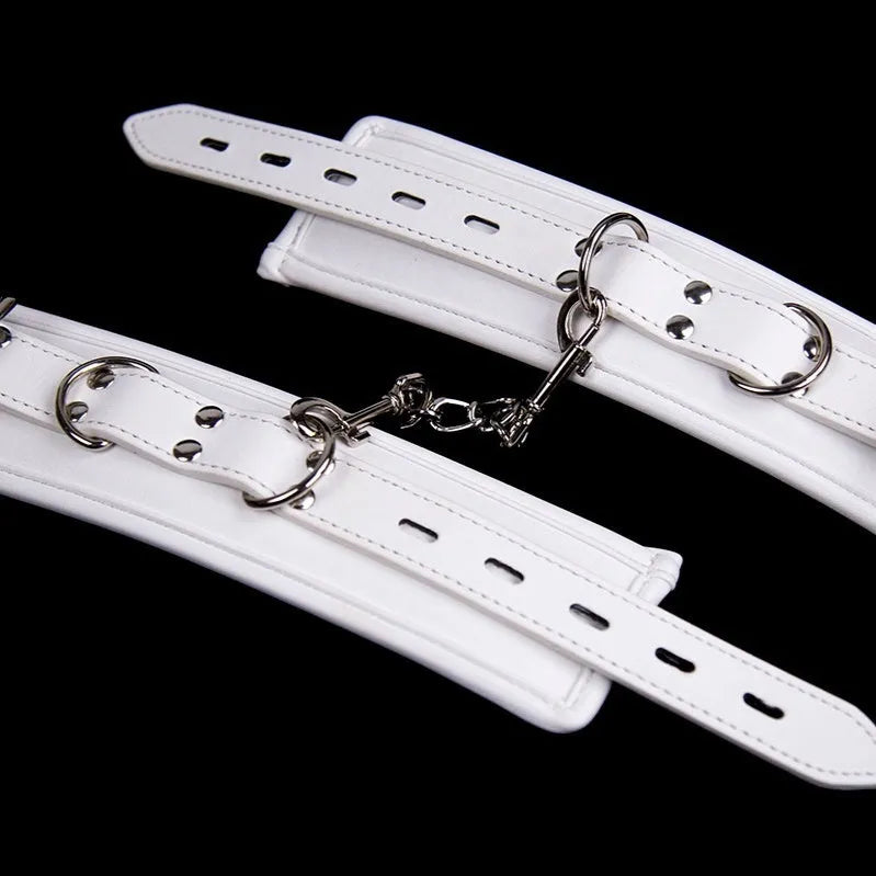 White PU sponge bondage cuffs set showing handcuffs, foot cuffs, and a neck cuff.