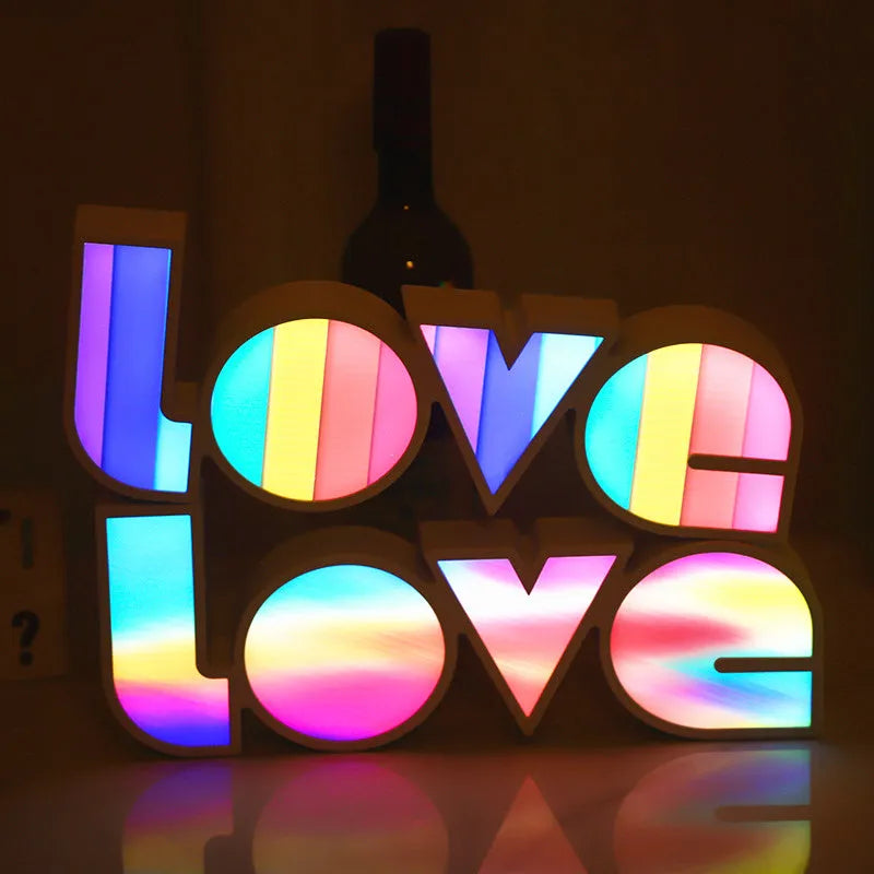 Rainbow style LED Love light for Valentines Day and wedding decoration on a table.