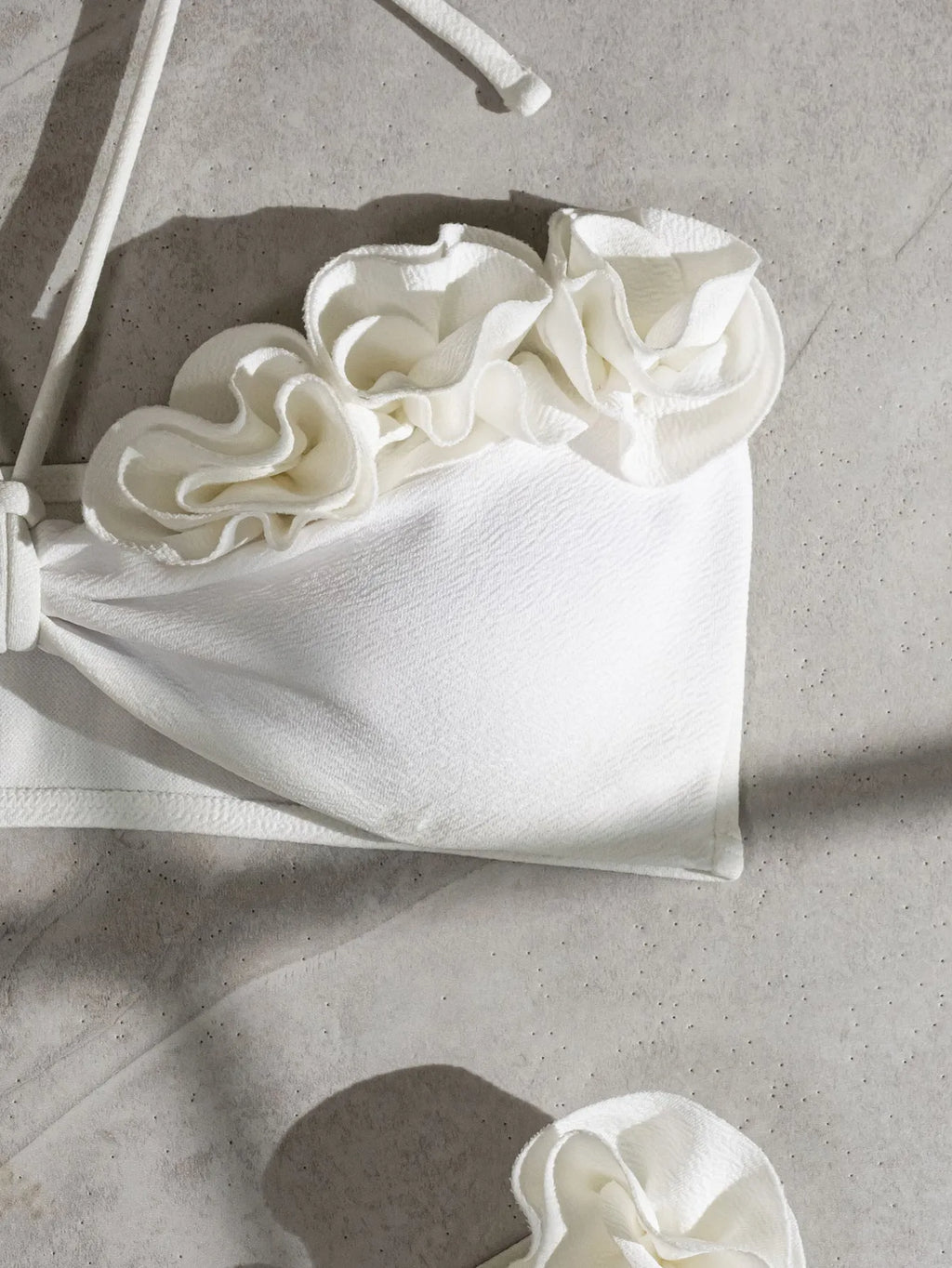 White halter neck lace-up bikini with split-cup design and three-dimensional floral details
