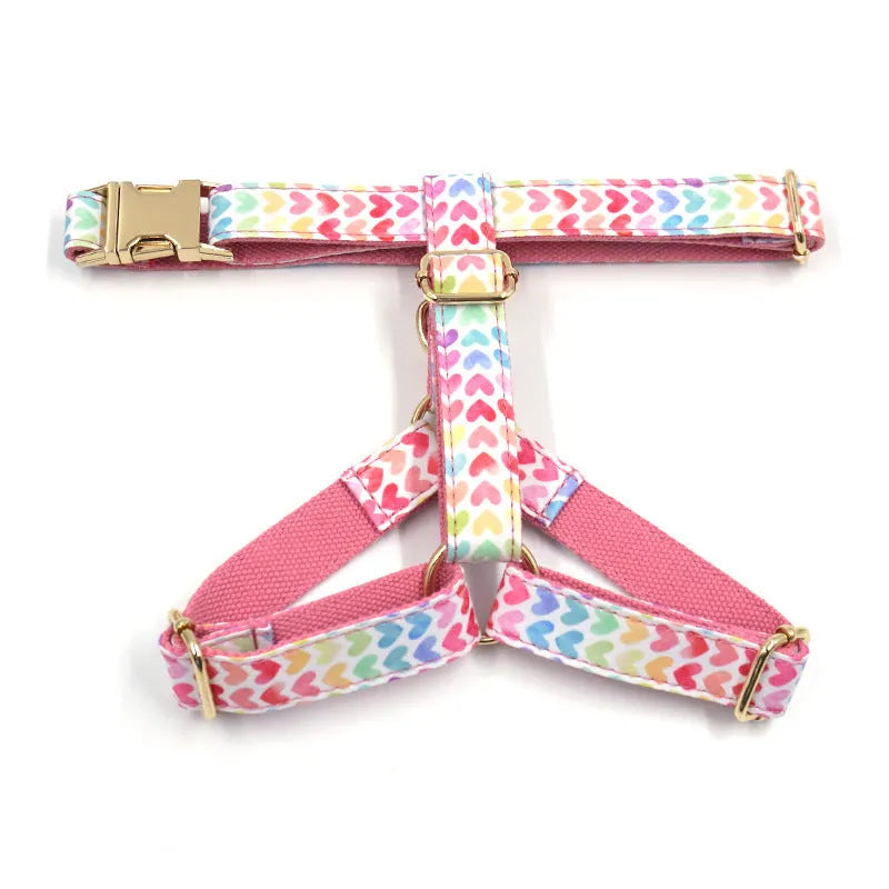 Pink colourful dog harness with heart-shaped stones and gold buckle fastenings on chest and back support design