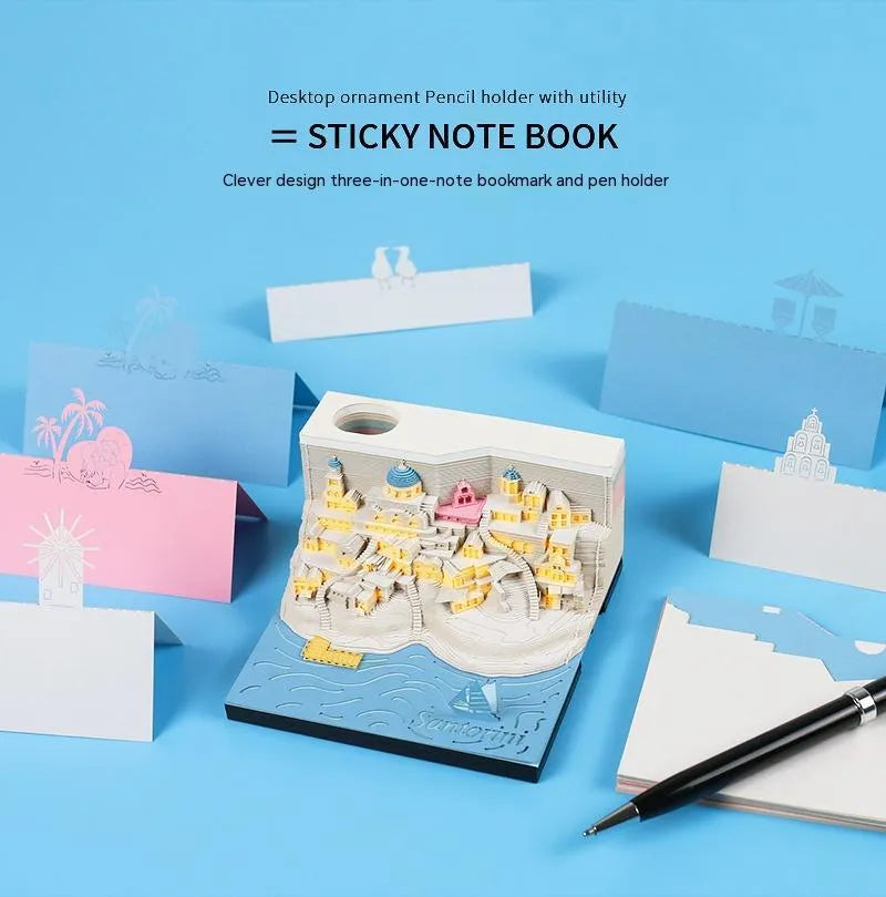 Assembled Santorini beach 3D paper model notepad with decorative lighting on a desk.