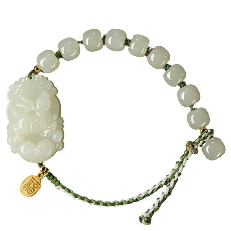 Year of Rabbit red rope bracelet with Hetian jade bead and S925 silver card on a white background.
