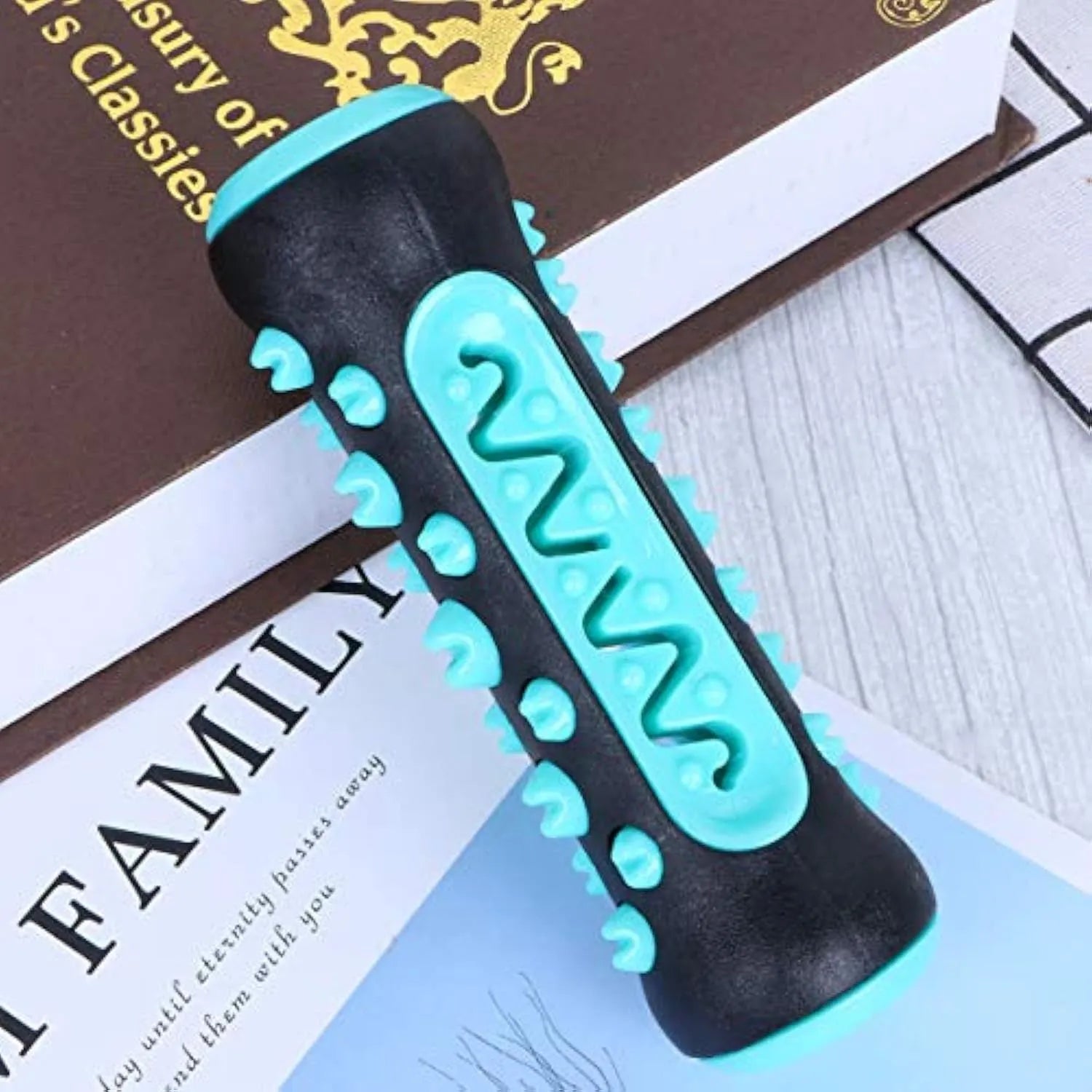 Natural rubber dog dental chew toy in blue, showing textured toothbrush design.