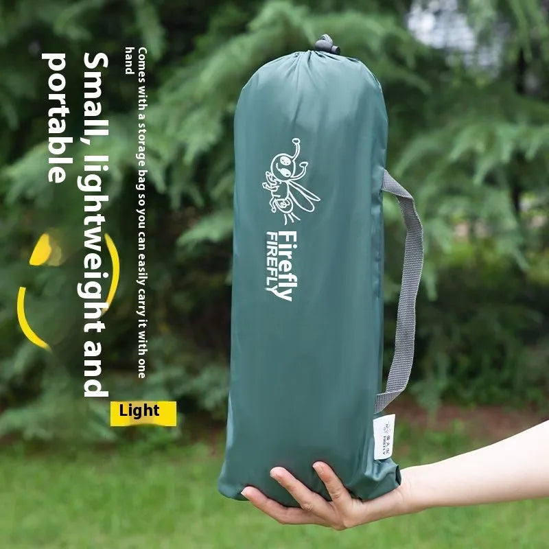 Single-person manual camping tent in army green, set up outdoors with fibre-glass poles.