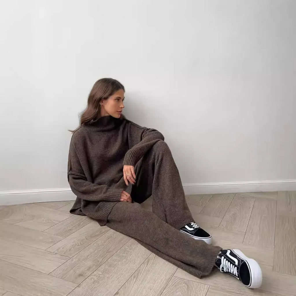 Women's dark grey knit co-ord suit with side-slit sweater top and matching trousers.