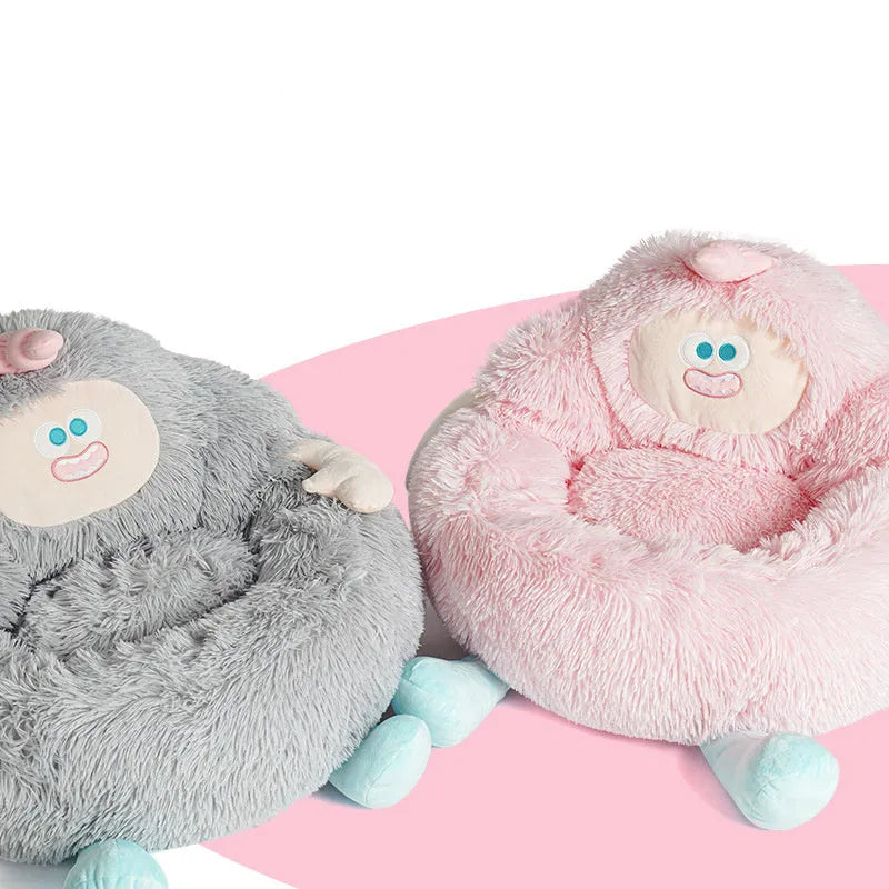 Grey plush round pet nest bed with raised rim for cats and dogs, shown in a home setting.