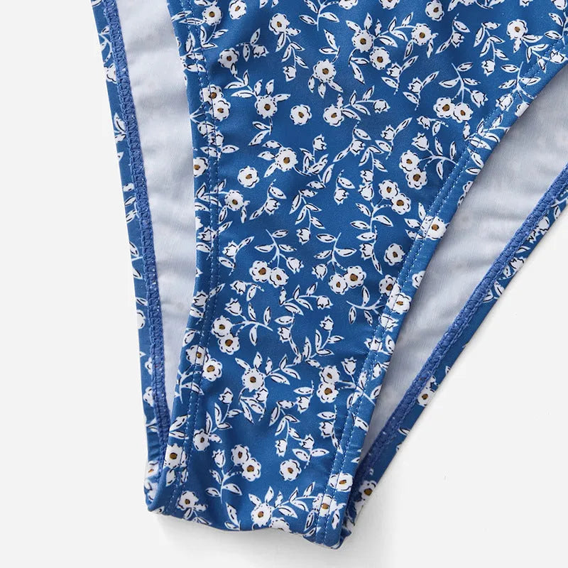 Blue polyester three-piece swimsuit set comprising a rash vest and matching shorts.
