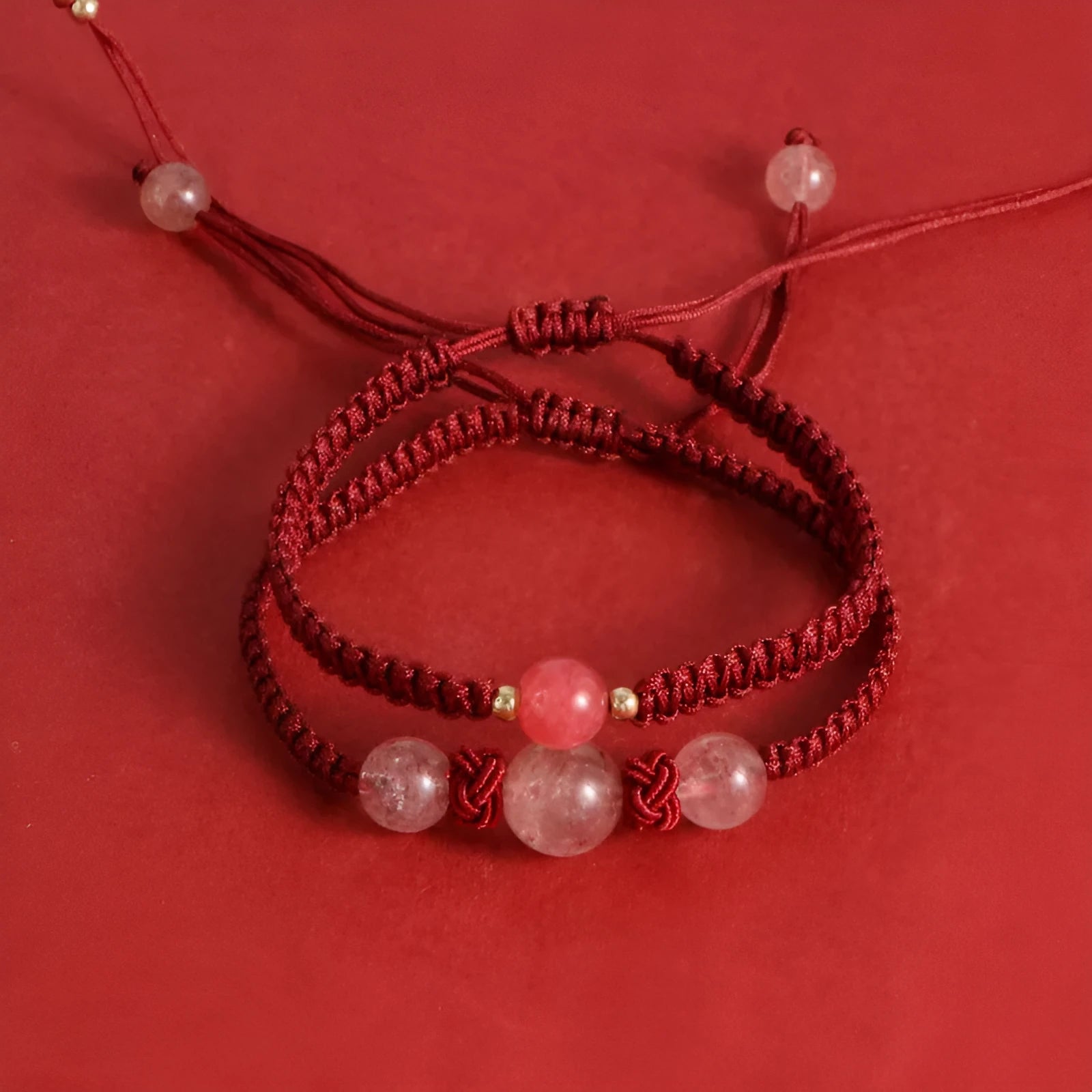 Woven red rope bracelet with spherical strawberry quartz beads and alloy clasp