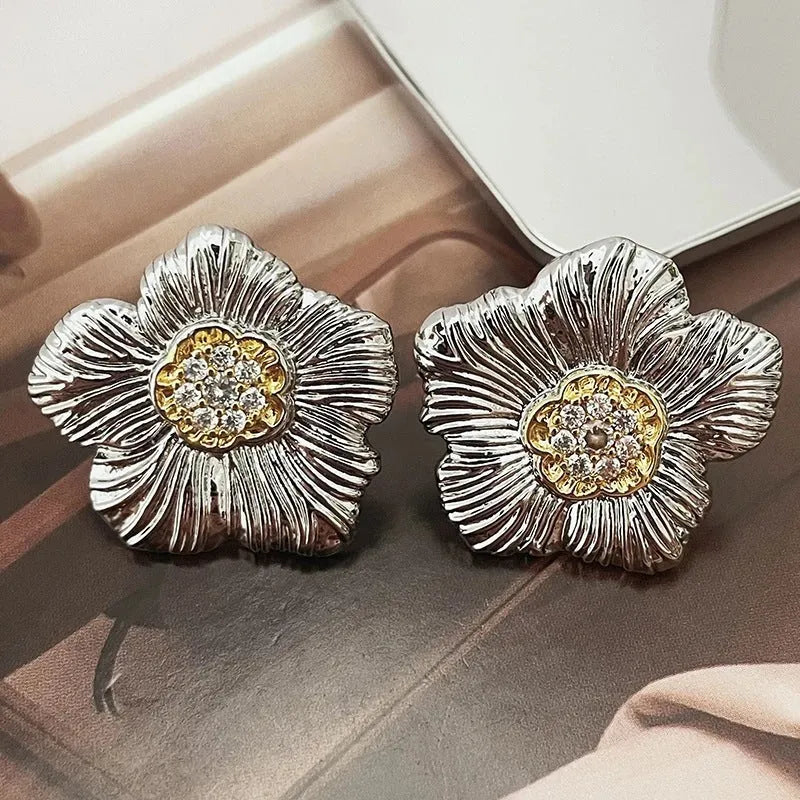 Copper stud earrings with textured gardenia flower design and two-tone electroplated finish.