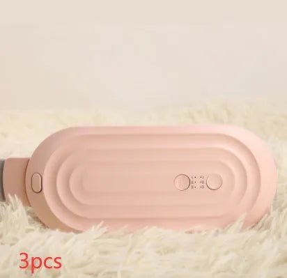 Pink and white menstrual heating belt with USB charger, controller, and long cable on a grey background.