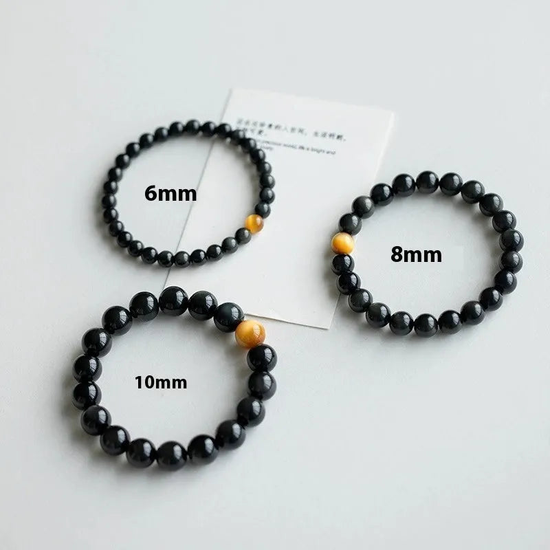 Black geometric obsidian bead bracelet shown in three size options: 6mm, 8mm, and 10mm beads.