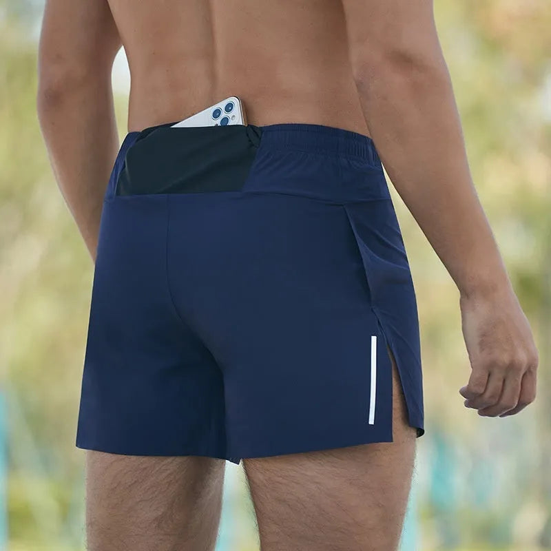 Man wearing high-waisted, loose-fit black off-road running shorts for marathon training.