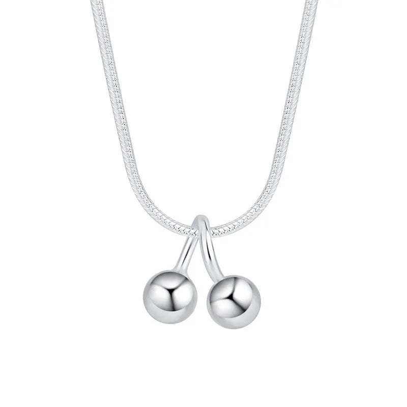 Silver cherry fruit pendant necklace on an adjustable snake bone chain for women.