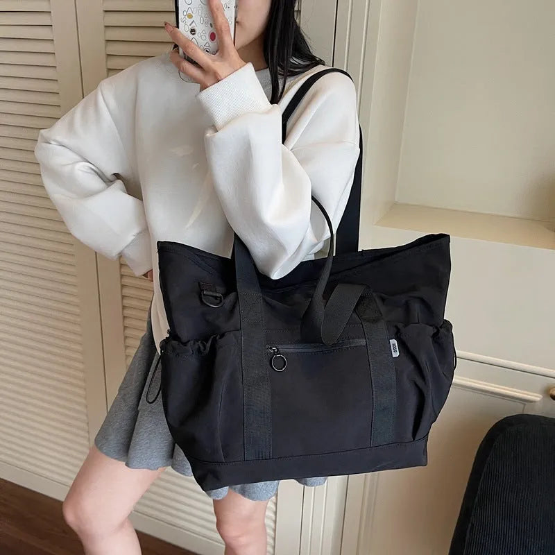 Grey women's lightweight Oxford cloth travel holdall for yoga and fitness.