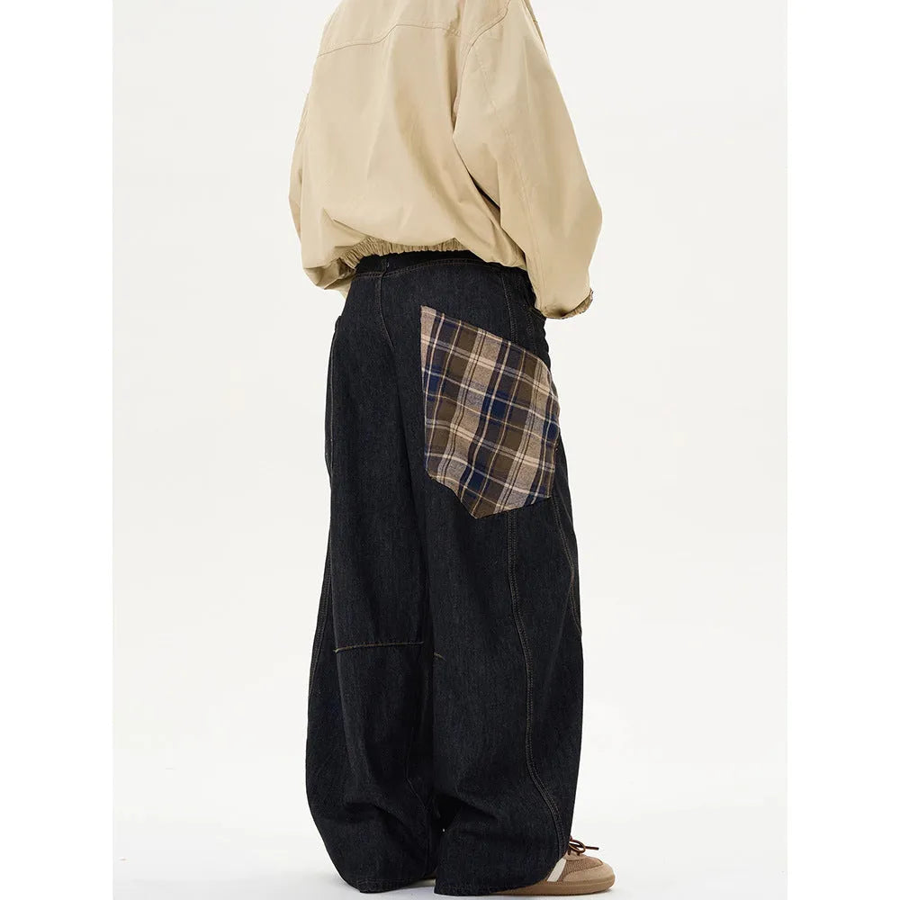 Man wearing loose straight-leg casual trousers in a red plaid pattern.