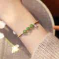 Hetian jade bracelet with diamond weave and lotus design in light green or haze blue