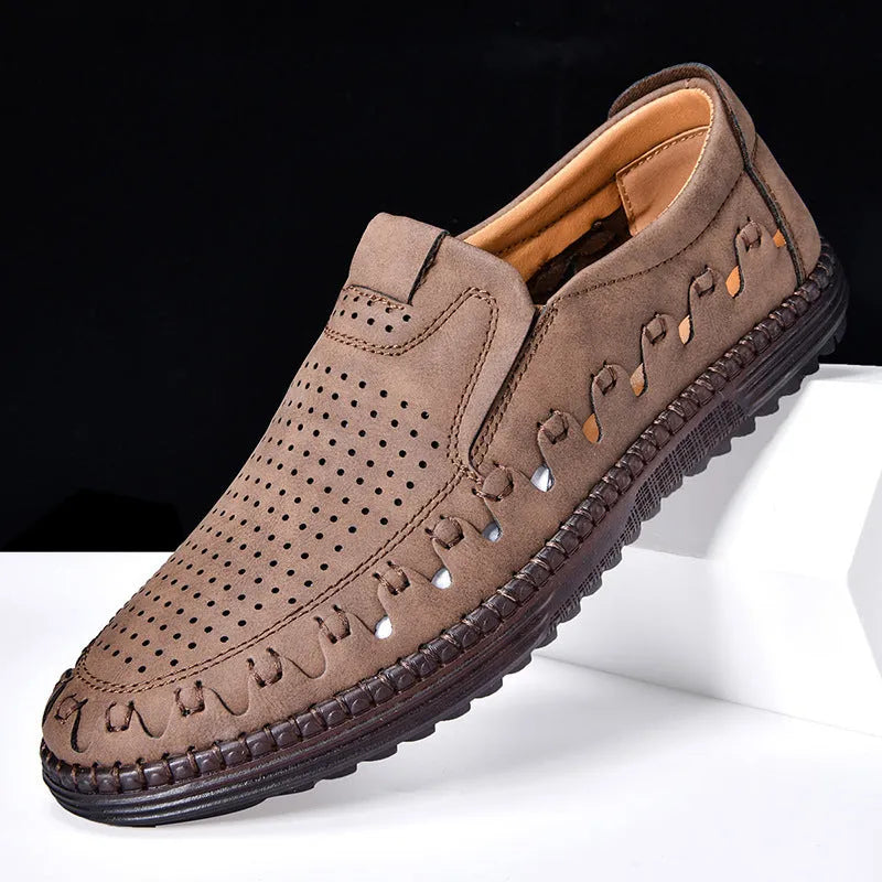 Men's brown casual slip-on shoes with round toe, low top, and sleeve entry design on a plain background.