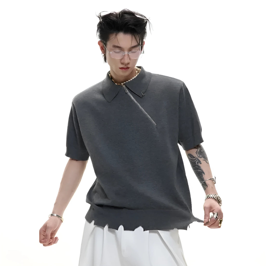 Man wearing a slim-fit black knitted polo shirt with an oblique diagonal zipper and lapel collar.