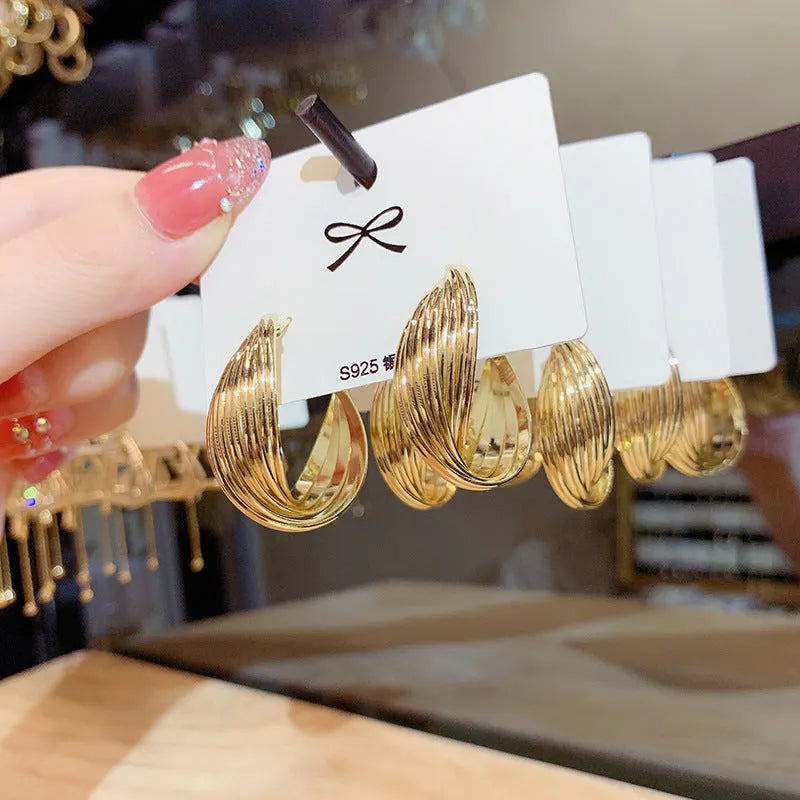 Twisted metal eardrop earring with real gold plating, geometric round shape, and stranded multi-layer design in gold colour