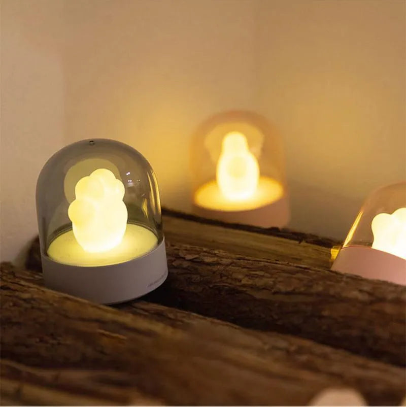 Grey or pink cat paw shaped USB rechargeable night light with rotating soft light and music box feature