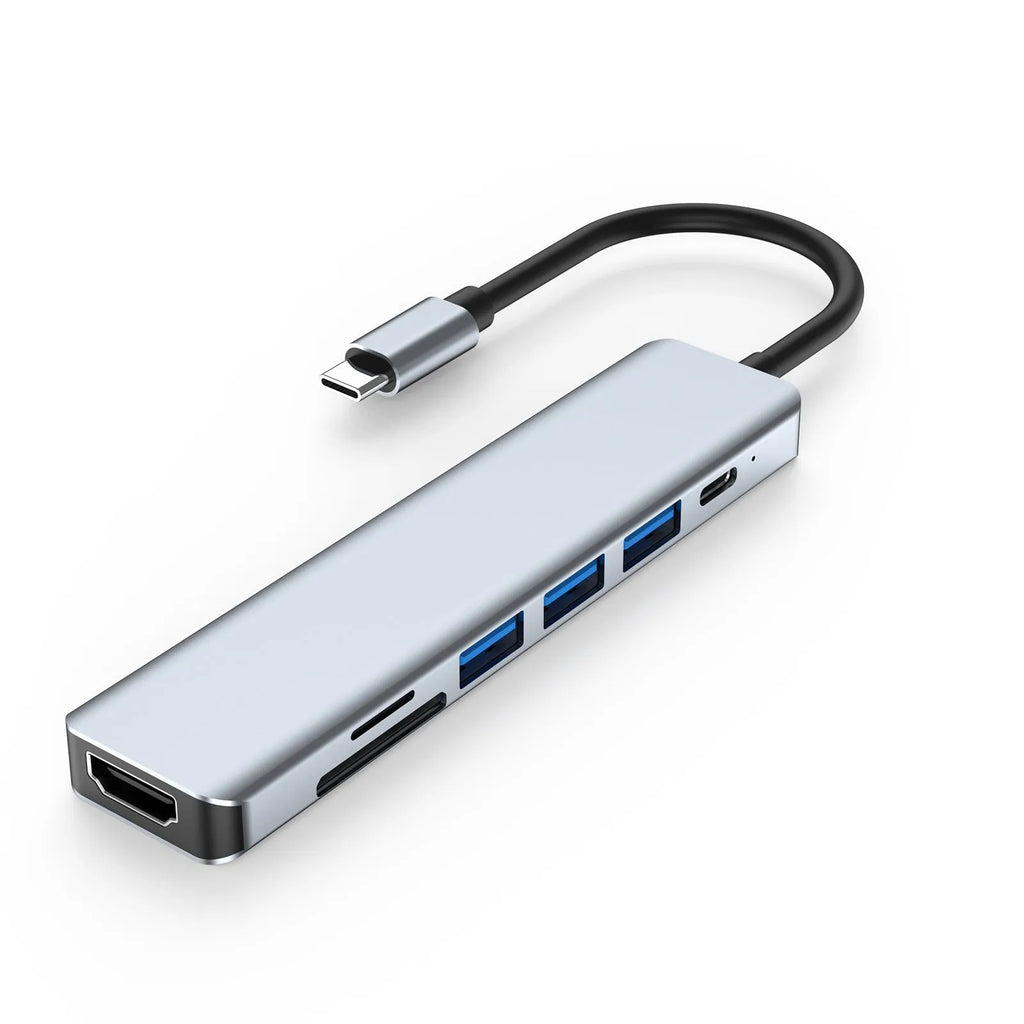 Seven-port USB-C hub expander with short cable shown next to a laptop.