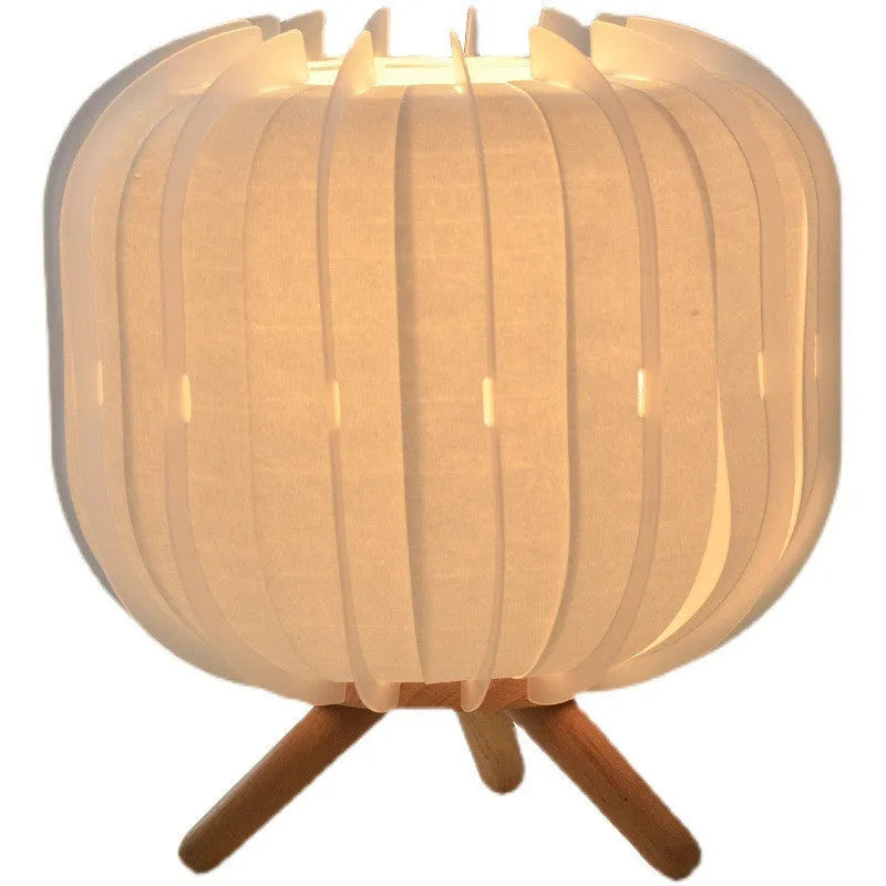 Handmade walnut wood small table lamp with beige pleated cloth shade and LED light on a desk
