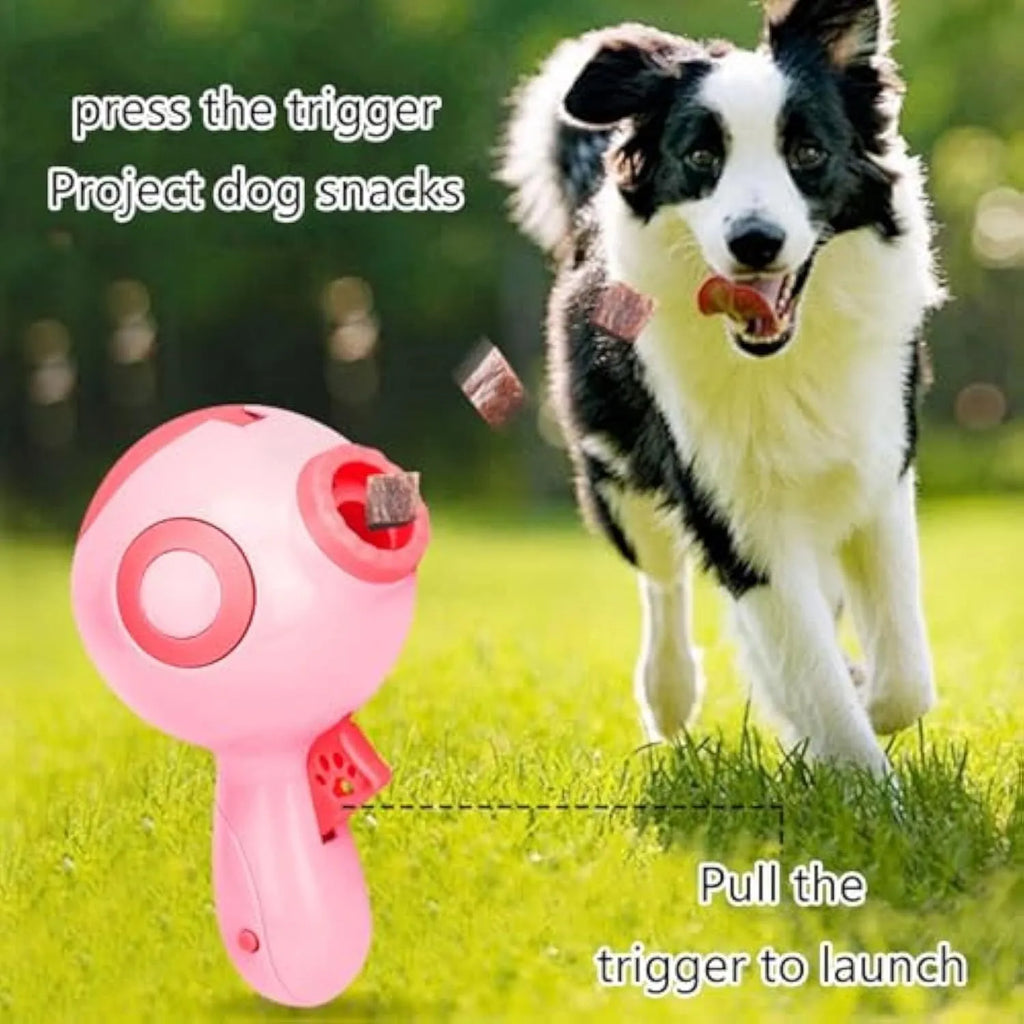 Green, orange, and pink plastic dog treat launcher toy with dispenser for interactive play and training.