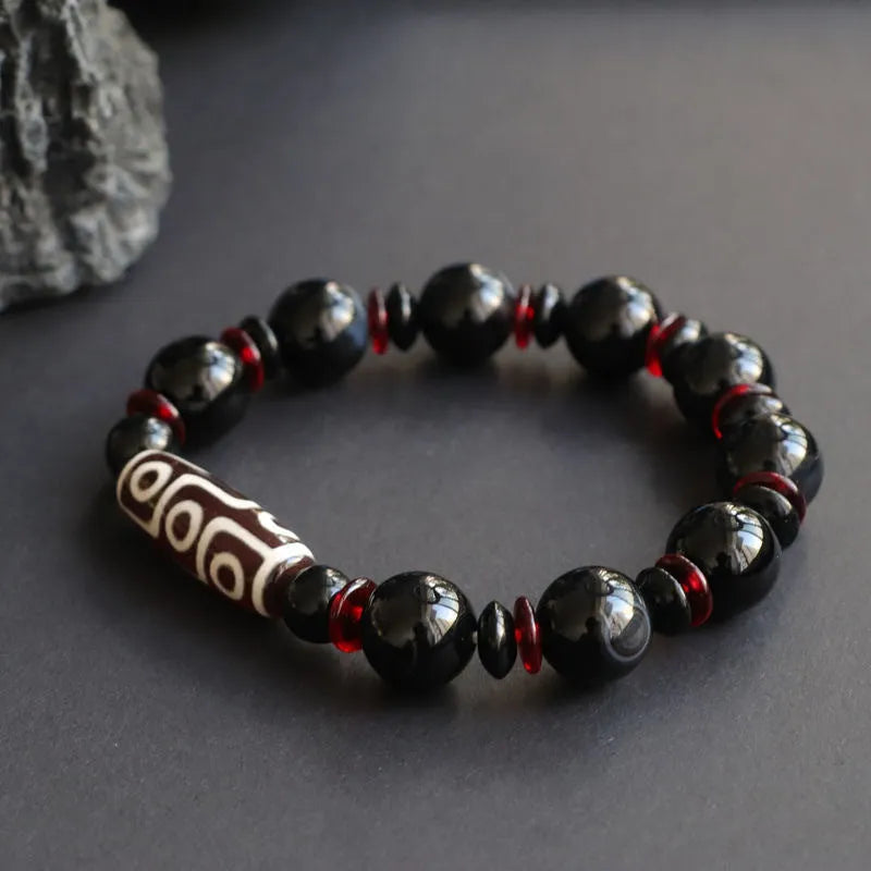 Black agate dzi bead bracelet with 11mm geometric beads and hand-woven construction