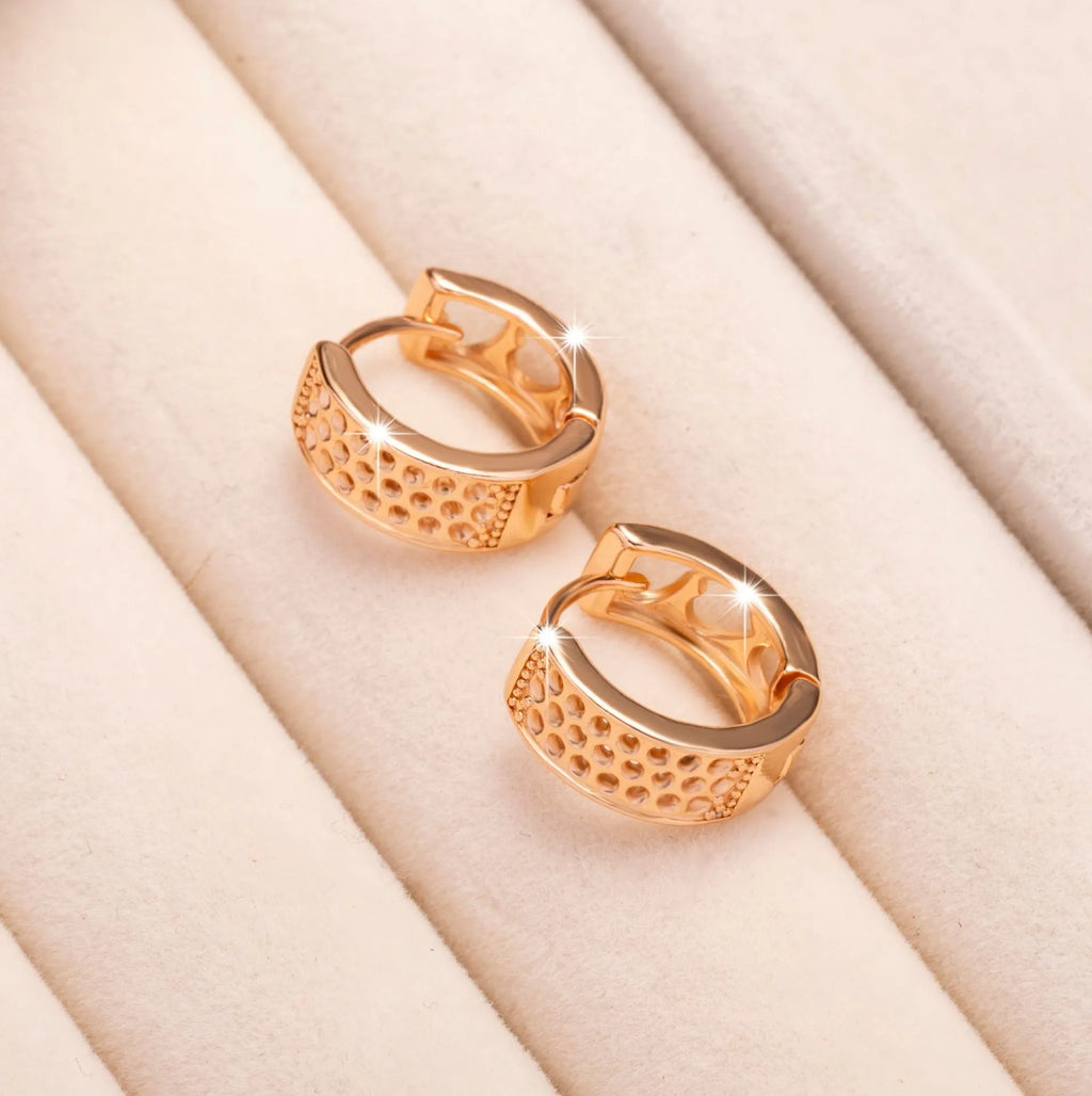 Rose gold tone women's earrings with a hollowed-out heart shape divided into three sections.