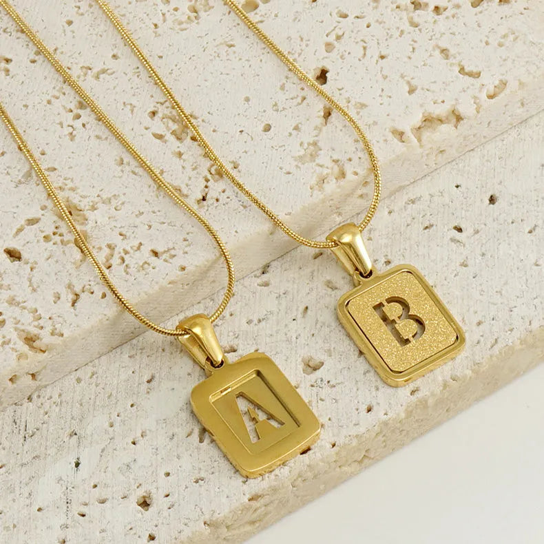 Alphabet necklace with square hollow-out letter pendant in titanium steel, gold or silver electroplated small snake chain