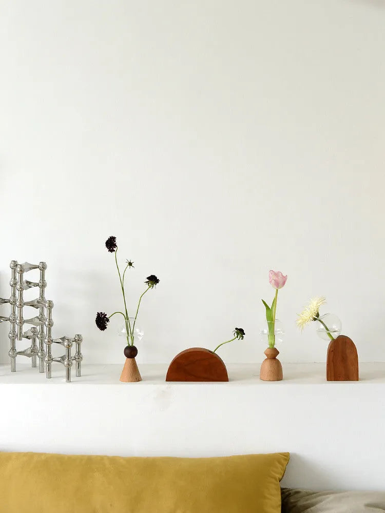 Small clear glass bubble vase on a wooden base, shown in conical bottom and arc bottom styles.