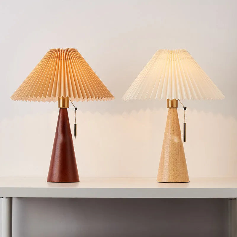 Handmade walnut wood small table lamp with beige pleated cloth shade and LED light on a desk