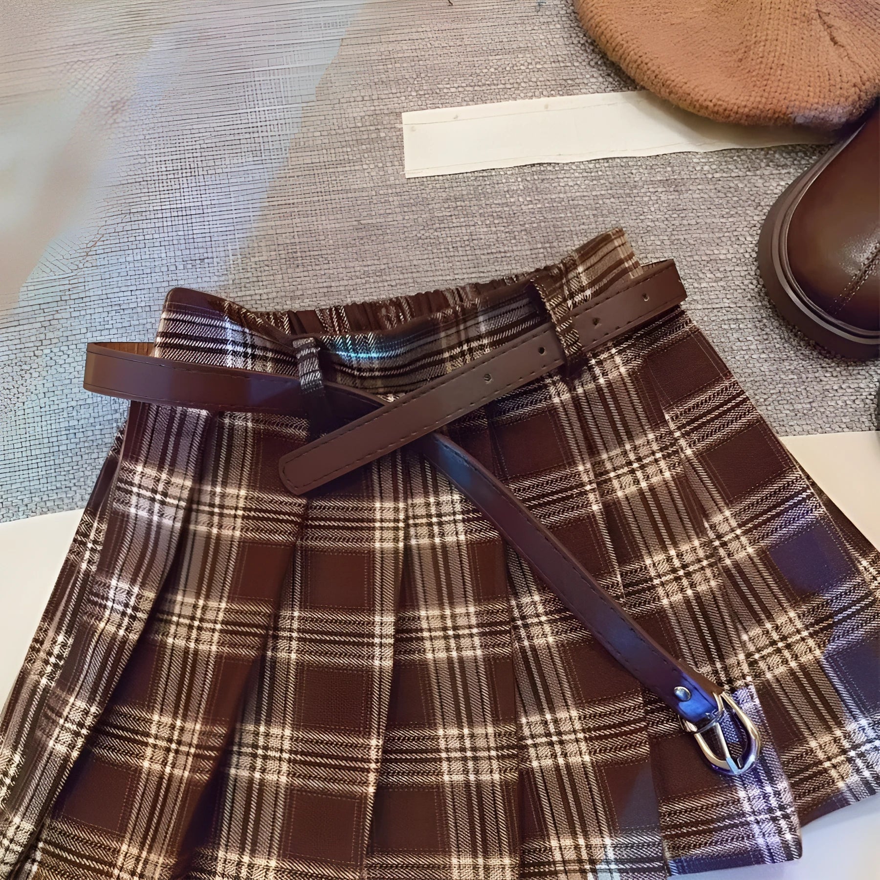 Girls' red and black plaid pleated A-line skirt with a cotton blend fabric.