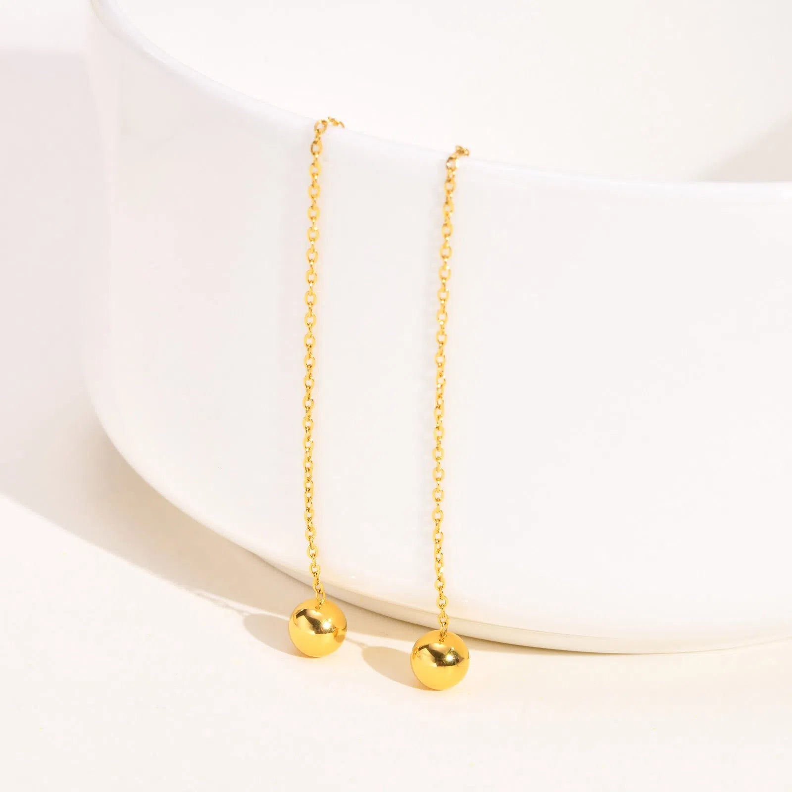 Gold-tone minimalist drop earrings made of alloy with small golden beads for women