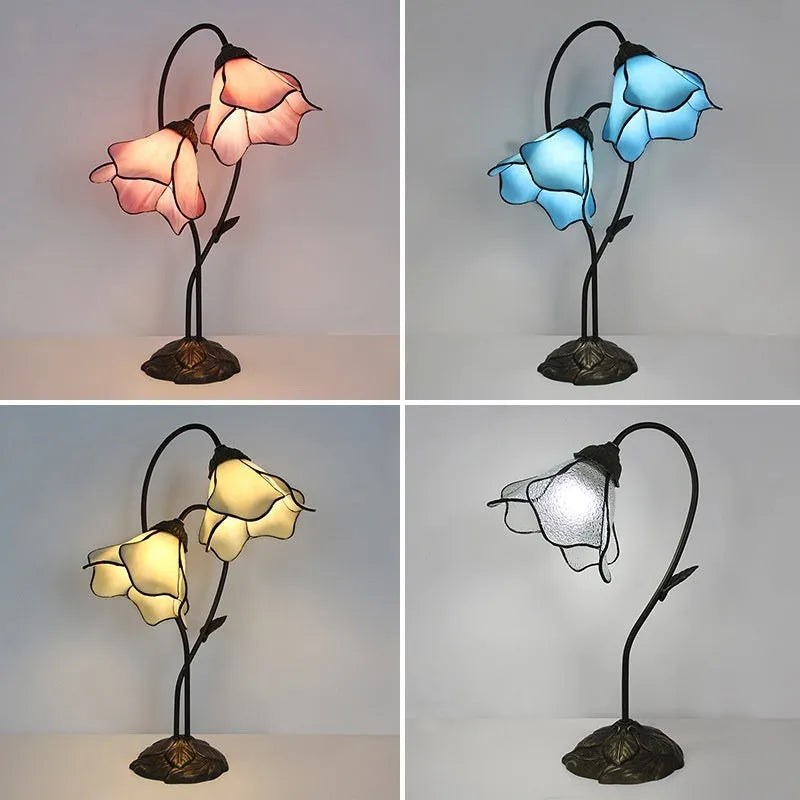 Retro American style table lamp with coloured glass lotus design shade on wooden surface